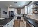 Spacious kitchen with white cabinetry, stainless steel appliances, and wood flooring at 12238 W Patrick Ct, Sun City, AZ 85373