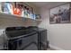 The laundry room boasts modern, energy-efficient appliances, plus storage for detergents and supplies at 12238 W Patrick Ct, Sun City, AZ 85373