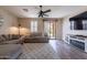 Comfortable living room with plush sofas, ceiling fan, and slider to back yard at 12238 W Patrick Ct, Sun City, AZ 85373