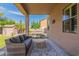 Cozy covered patio with comfortable seating, providing a relaxing outdoor living space at 12238 W Patrick Ct, Sun City, AZ 85373