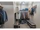 Well-organized walk-in closet with ample hanging space and shoe racks for efficient storage solutions at 12238 W Patrick Ct, Sun City, AZ 85373