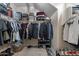 Spacious walk-in closet with organized shelves, hanging racks, and shoe storage, maximizing storage and convenience at 12238 W Patrick Ct, Sun City, AZ 85373