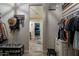 Walk-in closet leading to bedroom, featuring hat rack, clothing racks and shoe storage, blending convenience and accessibility at 12238 W Patrick Ct, Sun City, AZ 85373