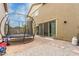 Backyard with a trampoline, brick patio, and neutral stucco exterior at 13380 N 148Th Ave, Surprise, AZ 85379