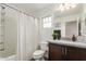 Bright bathroom featuring a shower-tub combo, neutral walls, and a stylish vanity with decor accents at 13380 N 148Th Ave, Surprise, AZ 85379