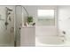 Relaxing bathroom with a separate shower and a soaking tub, accented by natural light at 13380 N 148Th Ave, Surprise, AZ 85379