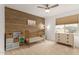 Cozy bedroom featuring a wood accent wall, neutral decor, and natural lighting at 13380 N 148Th Ave, Surprise, AZ 85379