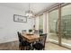 Modern dining room featuring a rustic wooden table and a stylish light fixture at 13380 N 148Th Ave, Surprise, AZ 85379