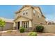 Well-maintained two-story home featuring a covered porch, decorative stonework, and tidy landscaping at 13380 N 148Th Ave, Surprise, AZ 85379