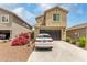 Attractive two-story home with a dark-colored garage door and well-maintained landscaping at 13380 N 148Th Ave, Surprise, AZ 85379