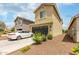 Charming two-story home with a well-kept front yard, complemented by a white car in the driveway at 13380 N 148Th Ave, Surprise, AZ 85379