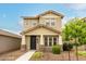Charming two-story home featuring a covered front porch and low-maintenance landscaping at 13380 N 148Th Ave, Surprise, AZ 85379