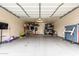 Organized two-car garage with epoxy flooring and ample storage space for various items at 13380 N 148Th Ave, Surprise, AZ 85379