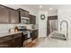 Modern kitchen with stainless steel appliances, granite countertops, and dark wood cabinetry at 13380 N 148Th Ave, Surprise, AZ 85379