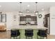 Bright kitchen featuring a large island with bar seating, stainless appliances, and modern pendant lighting at 13380 N 148Th Ave, Surprise, AZ 85379