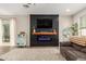 Comfortable living room featuring a modern electric fireplace and a cozy seating area at 13380 N 148Th Ave, Surprise, AZ 85379
