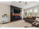 Cozy living room with electric fireplace, plush seating, and a bright, airy feel at 13380 N 148Th Ave, Surprise, AZ 85379