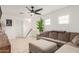 Spacious living room featuring a large sectional sofa, ceiling fan, and ample natural light at 13380 N 148Th Ave, Surprise, AZ 85379