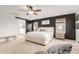 Primary bedroom features a ceiling fan, a dark accent wall, and a barn door to the bathroom at 13380 N 148Th Ave, Surprise, AZ 85379