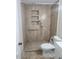 Bathroom with large tiled shower, including built-in shelves at 138 E Monte Way, Phoenix, AZ 85042
