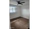 Cozy bedroom with neutral walls, ceiling fan, carpet floors, and a bright window at 138 E Monte Way, Phoenix, AZ 85042