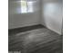 This cozy bedroom features wood floors and a bright window, creating a serene and inviting atmosphere at 138 E Monte Way, Phoenix, AZ 85042