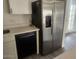 Kitchen detail with stainless steel refrigerator, black dishwasher, and stone countertops at 138 E Monte Way, Phoenix, AZ 85042