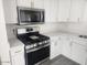 Close up of range and microwave, showing white cabinets, quartz countertops at 138 E Monte Way, Phoenix, AZ 85042