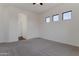 Large bedroom with neutral carpeting and bright natural light and arched entryway at 15240 N 142Nd Ave # 2171, Surprise, AZ 85379