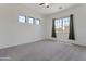 Spacious bedroom with plush carpet, ample natural light, and a ceiling fan at 15240 N 142Nd Ave # 2171, Surprise, AZ 85379