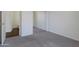 Bedroom with plush carpet, a mirror closet, and an adjoining bathroom at 15240 N 142Nd Ave # 2171, Surprise, AZ 85379