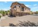 Attractive townhome featuring a three-car garage, desert landscaping, and neutral color palette at 15240 N 142Nd Ave # 2171, Surprise, AZ 85379