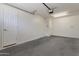 Clean garage with plenty of room for storage, including overhead lighting and door to inside at 15240 N 142Nd Ave # 2171, Surprise, AZ 85379