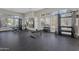 Community gym features weightlifting equipment, neutral color palette, ample lighting, and floor-to-ceiling windows at 15240 N 142Nd Ave # 2171, Surprise, AZ 85379