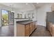 Kitchen bar adjoins an open plan living area with glass patio door leading to a balcony at 15240 N 142Nd Ave # 2171, Surprise, AZ 85379