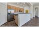 Open kitchen boasts stainless steel refrigerator and light wood cabinets, perfect for cooking at 15240 N 142Nd Ave # 2171, Surprise, AZ 85379