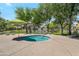 Community spa with an umbrella and seating is perfect for relaxation at 15240 N 142Nd Ave # 2171, Surprise, AZ 85379