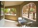 Cozy balcony with table and chairs, overlooking the community pool and lush landscaping for outdoor enjoyment at 15252 N 100Th St # 1172, Scottsdale, AZ 85260