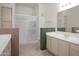 Bright bathroom with a shower behind glass doors and a double sink vanity at 15252 N 100Th St # 1172, Scottsdale, AZ 85260