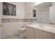 Well-lit bathroom featuring a toilet, vanity, and decorative elephant artwork at 15252 N 100Th St # 1172, Scottsdale, AZ 85260