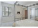 Bright bedroom featuring a four-poster bed, mounted TV, and mirrored closet doors at 15252 N 100Th St # 1172, Scottsdale, AZ 85260