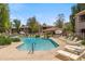 Inviting community pool surrounded by comfortable lounge chairs and shaded umbrellas at 15252 N 100Th St # 1172, Scottsdale, AZ 85260