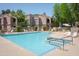 Sparkling community pool with lounge chairs, umbrellas, and a relaxing spa in a secure fenced area at 15252 N 100Th St # 1172, Scottsdale, AZ 85260