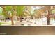View of the fenced community pool area surrounded by lush greenery and multi-story buildings at 15252 N 100Th St # 1172, Scottsdale, AZ 85260