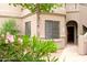 Inviting front entrance with well-maintained landscaping, including lush greenery and vibrant pink flowers at 15252 N 100Th St # 1172, Scottsdale, AZ 85260