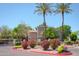 Well-maintained complex exterior with vibrant pink floral arrangements and mature palm trees in a tranquil setting at 15252 N 100Th St # 1172, Scottsdale, AZ 85260