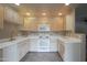 Well-lit kitchen showcasing lots of counter space, white appliances and cabinets at 15252 N 100Th St # 1172, Scottsdale, AZ 85260