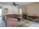 Cozy living room with a leather couch, fireplace, ceiling fan and neutral walls creating a warm atmosphere at 15252 N 100Th St # 1172, Scottsdale, AZ 85260