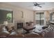 Inviting living room featuring a cozy fireplace, comfortable seating, and natural light from large windows at 15252 N 100Th St # 1172, Scottsdale, AZ 85260