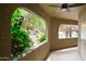 View from a patio featuring green foliage, stucco frame and ceiling fan at 15252 N 100Th St # 1172, Scottsdale, AZ 85260